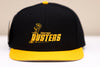 Broome Dusters™ Hat (Snapback) in black with yellow flat visor and vintage hockey team logo embroidered on front panel