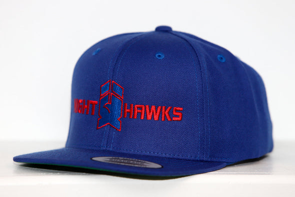 Blue New Haven Nighthawks snapback hat with red embroidered logo and flat brim on white background.