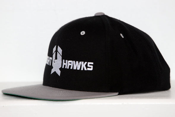 Black and gray snapback hat with New Haven Nighthawks logo embroidered on front panel