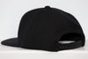 Columbus Chill Hat (Snapback) in black with adjustable strap and flat brim shown from back side