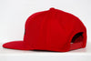 Red Long Island Ducks snapback hat with adjustable strap and flat brim shown from the side on white background