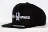 Black snapback hat featuring white embroidered New Haven Nighthawks logo on front panel with flat brim design.