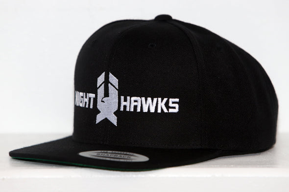Black snapback hat featuring white embroidered New Haven Nighthawks logo on front panel with flat brim design.