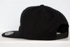 Black New Haven Nighthawks snapback hat with flat brim and adjustable strap shown from side angle