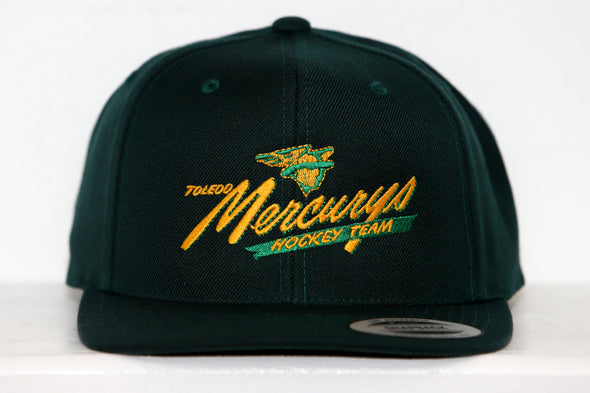 Dark green snapback hat with yellow Toledo Mercurys hockey team logo and vintage airplane embroidery on front panel.