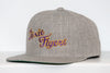 Gray snapback hat with embroidered Nashville Dixie Flyers logo in purple and gold thread