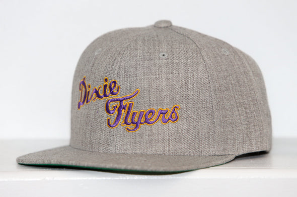 Gray snapback hat with embroidered Nashville Dixie Flyers logo in purple and gold thread