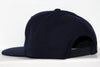 Back view of a navy blue Wichita Wind snapback hat with adjustable strap on a white background
