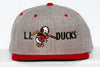 Gray and red Long Island Ducks snapback hat with embroidered cartoon duck holding a hockey stick on front panel