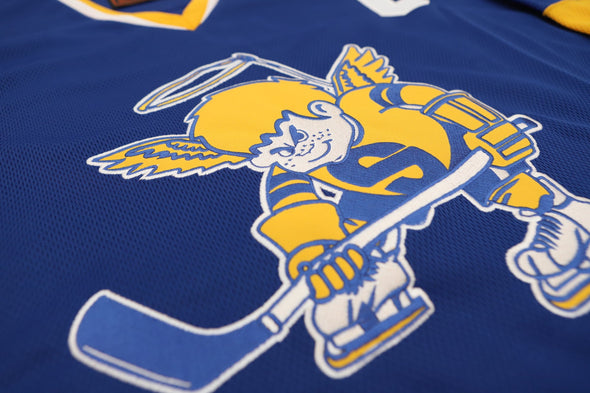 Minnesota Fighting Saints Jersey (CUSTOM - PRE-ORDER) in blue with vintage retro hockey player logo on front panel close-up
