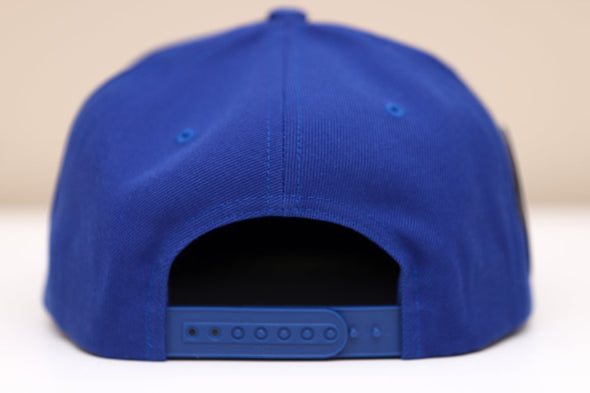 Back view of a blue Las Vegas Thunder snapback hat with adjustable strap on a neutral background